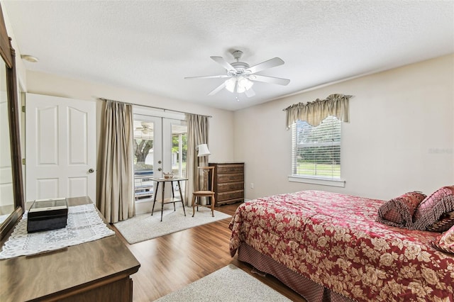 1202 Williams Rd, Plant City, FL 33565 - bedroom with french doors, wood finished floors, access to outside, a ceiling fan, and a textured ceiling