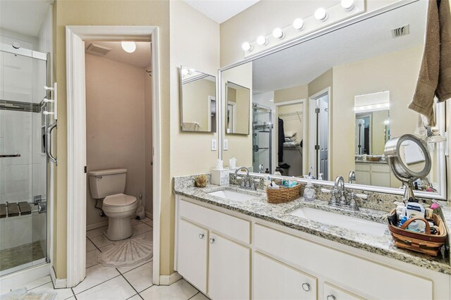 1202 Williams Rd, Plant City, FL 33565 - full bath featuring a stall shower, double vanity, tile patterned floors, toilet, and baseboards