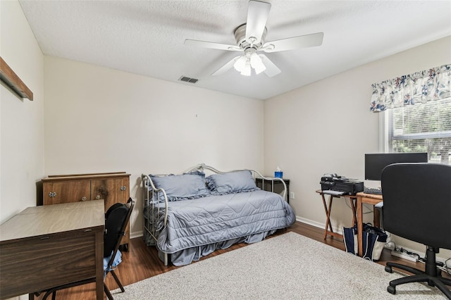 1202 Williams Rd, Plant City, FL 33565 - bedroom with a desk, wood finished floors, ceiling fan, and baseboards
