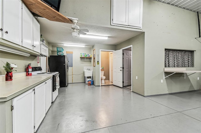 1202 Williams Rd, Plant City, FL 33565 - garage featuring freestanding refrigerator, ceiling fan, a sink, and electric panel