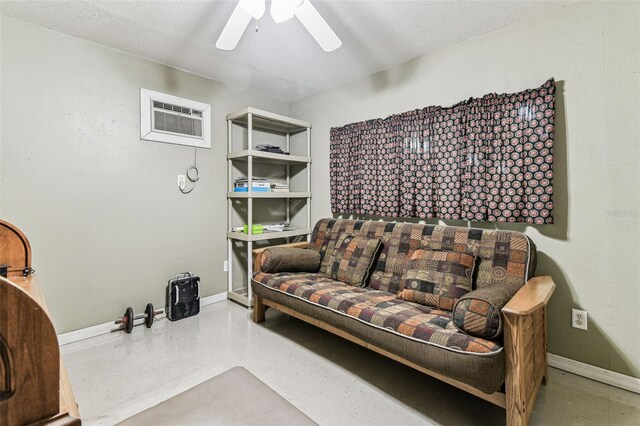 1202 Williams Rd, Plant City, FL 33565 - living area with a wall unit AC, a ceiling fan, and baseboards