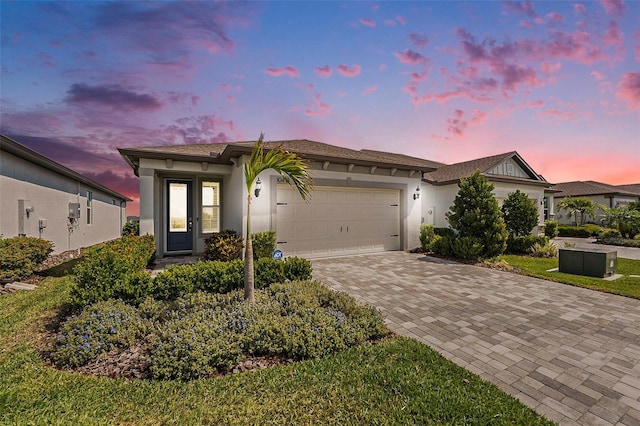 10418 Spring Tide Way, Parrish, FL 34219 - ranch-style home with decorative driveway, stucco siding, and an attached garage