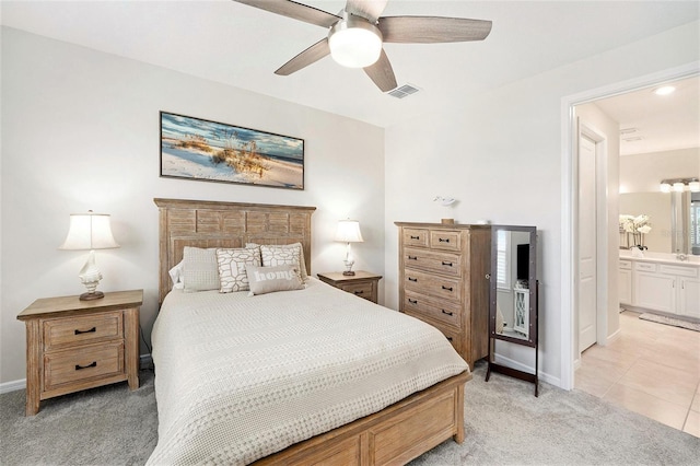 10418 Spring Tide Way, Parrish, FL 34219 - bedroom with light colored carpet, baseboards, ensuite bathroom, ceiling fan, and light tile patterned flooring