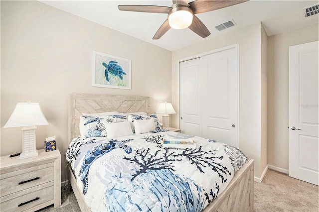10418 Spring Tide Way, Parrish, FL 34219 - bedroom with light carpet, a closet, baseboards, and a ceiling fan