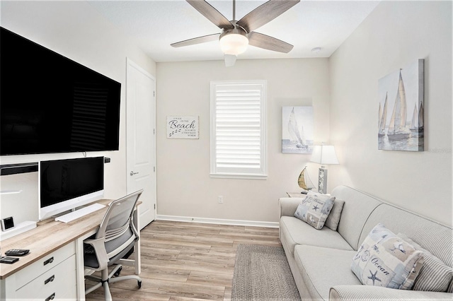 10418 Spring Tide Way, Parrish, FL 34219 - home office featuring light wood-style flooring, a ceiling fan, and baseboards