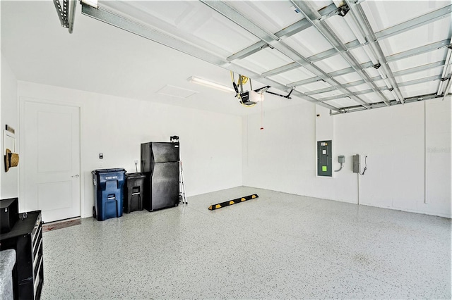 10418 Spring Tide Way, Parrish, FL 34219 - garage featuring electric panel, freestanding refrigerator, and a garage door opener
