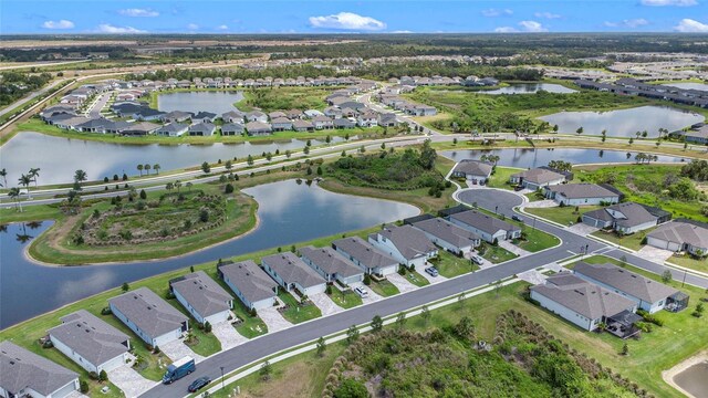 10418 Spring Tide Way, Parrish, FL 34219 - aerial view of property and surrounding area with nearby suburban area and a large body of water