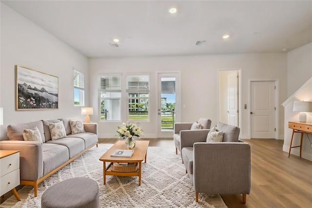 7232 Sutton Ln, Sarasota, FL 34240 - living room with light wood-style flooring, recessed lighting, and baseboards