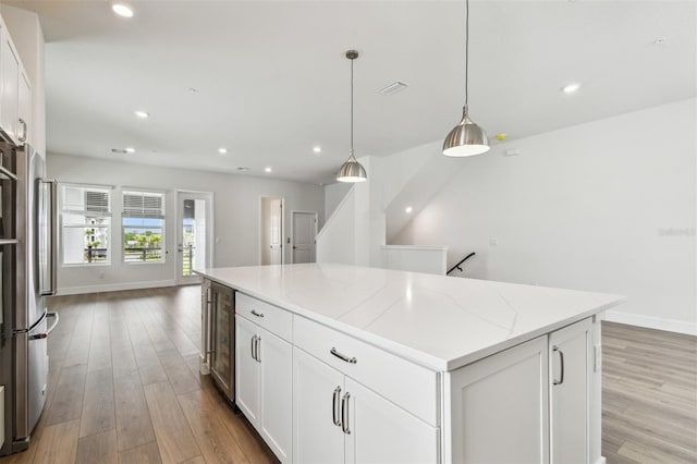 7232 Sutton Ln, Sarasota, FL 34240 - kitchen featuring light wood finished floors, a center island, baseboards, and recessed lighting