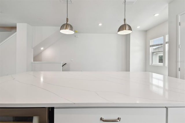 7232 Sutton Ln, Sarasota, FL 34240 - kitchen featuring beverage cooler, recessed lighting, hanging light fixtures, and light stone counters