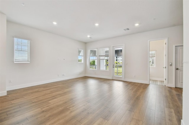 7232 Sutton Ln, Sarasota, FL 34240 - unfurnished room with light wood-type flooring, baseboards, and recessed lighting