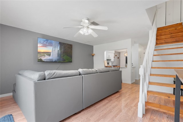 16504 Lake Brigadoon Cir, Tampa, FL 33618 - living area with stairs, ceiling fan, baseboards, and light wood-style floors
