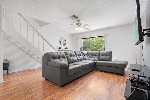 16504 Lake Brigadoon Cir, Tampa, FL 33618 - living area featuring light wood finished floors, stairway, a ceiling fan, and baseboards