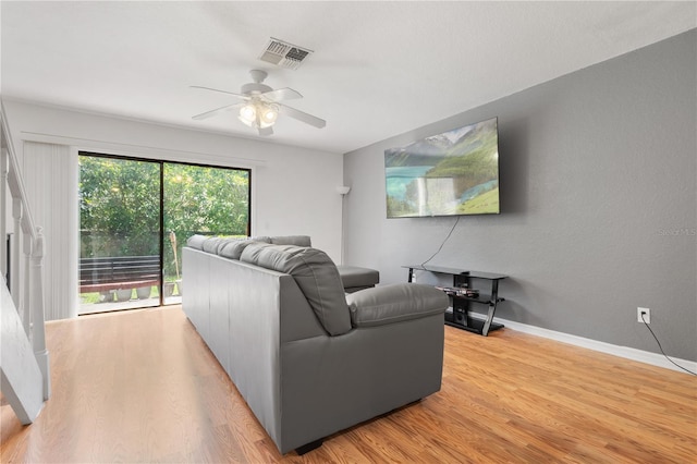 16504 Lake Brigadoon Cir, Tampa, FL 33618 - living area with light wood finished floors, a ceiling fan, and baseboards