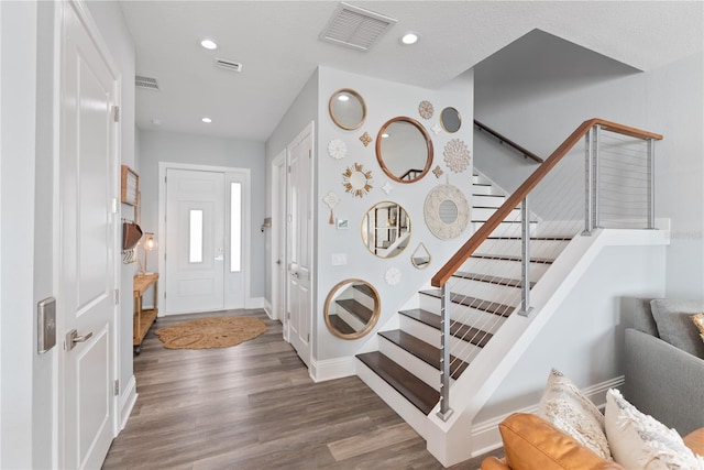 foyer featuring stairs, wood finished floors, recessed lighting, and baseboards