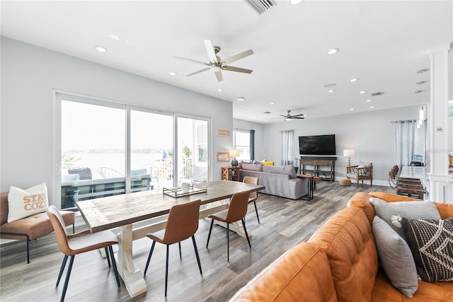 dining area with a ceiling fan, recessed lighting, light wood-style floors, and baseboards