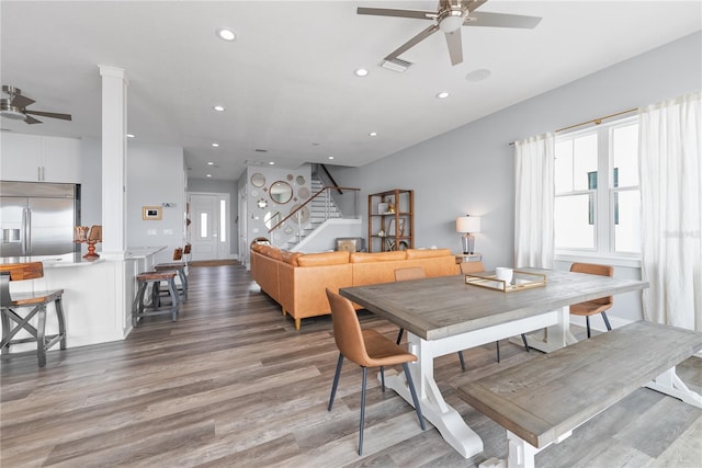 dining room featuring a ceiling fan, stairs, light wood-style flooring, and recessed lighting