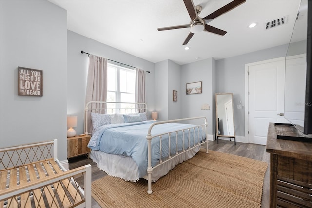 bedroom featuring wood finished floors, baseboards, recessed lighting, and ceiling fan