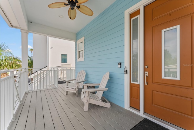 wooden terrace featuring a ceiling fan