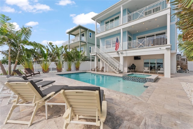 view of pool featuring a patio, stairs, a pool with connected hot tub, and a fenced backyard