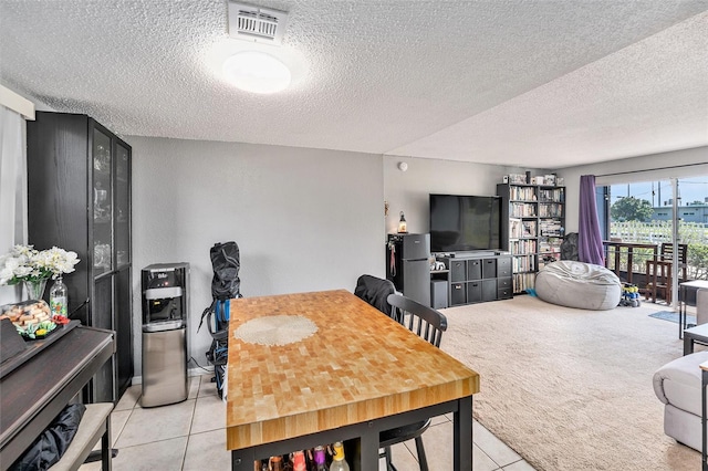 200 Country Club Dr Unit 403, Largo, FL 33771 - dining space with light tile patterned floors, a textured ceiling, and light colored carpet