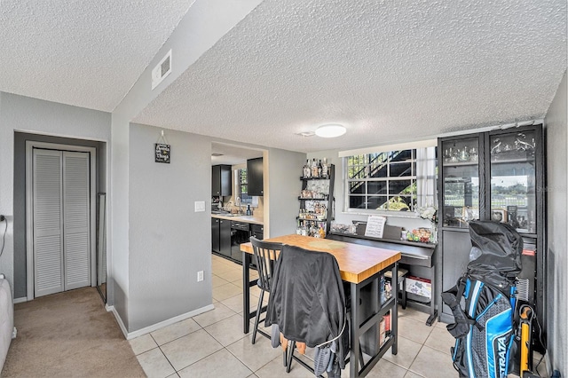 200 Country Club Dr Unit 403, Largo, FL 33771 - dining area featuring a textured ceiling, light tile patterned flooring, and baseboards