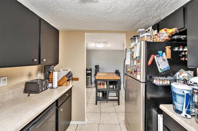 200 Country Club Dr Unit 403, Largo, FL 33771 - kitchen with light tile patterned floors, a textured ceiling, light countertops, freestanding refrigerator, and dishwasher