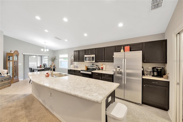 305 St Georges Cir, Eagle Lake, FL 33839 - kitchen featuring appliances with stainless steel finishes, vaulted ceiling, light countertops, a sink, and a center island with sink