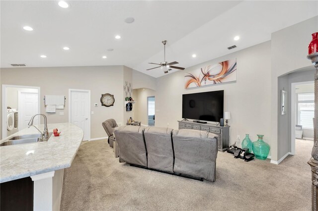 305 St Georges Cir, Eagle Lake, FL 33839 - living room featuring light colored carpet, washer / clothes dryer, arched walkways, a ceiling fan, and lofted ceiling