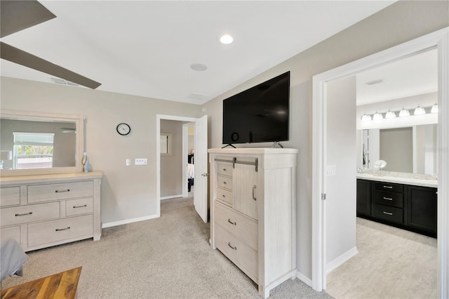 305 St Georges Cir, Eagle Lake, FL 33839 - bedroom with baseboards, light carpet, and ensuite bath