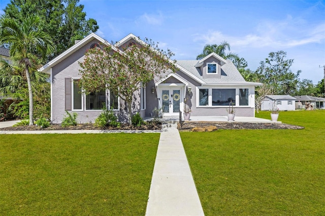 308 Chauncey Ave, Bradenton, FL 34208 - view of front facade featuring stucco siding, a front lawn, and french doors