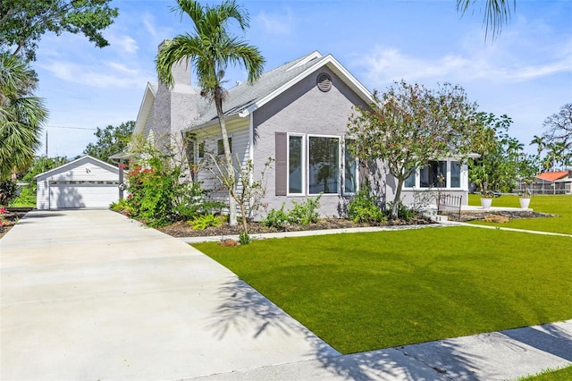 308 Chauncey Ave, Bradenton, FL 34208 - craftsman house featuring a front lawn, an outbuilding, stucco siding, and a garage