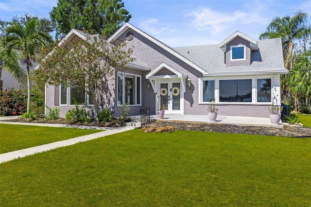 308 Chauncey Ave, Bradenton, FL 34208 - view of front of home featuring a front lawn, stucco siding, and french doors