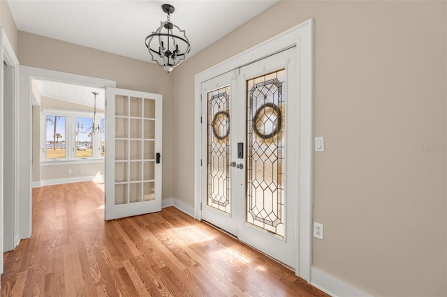 308 Chauncey Ave, Bradenton, FL 34208 - foyer featuring a chandelier, baseboards, french doors, and light wood-type flooring