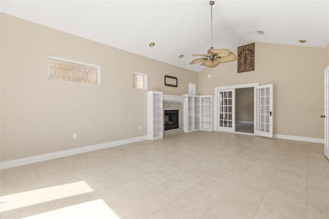 308 Chauncey Ave, Bradenton, FL 34208 - unfurnished living room featuring a tile fireplace, light tile patterned floors, french doors, high vaulted ceiling, and ceiling fan