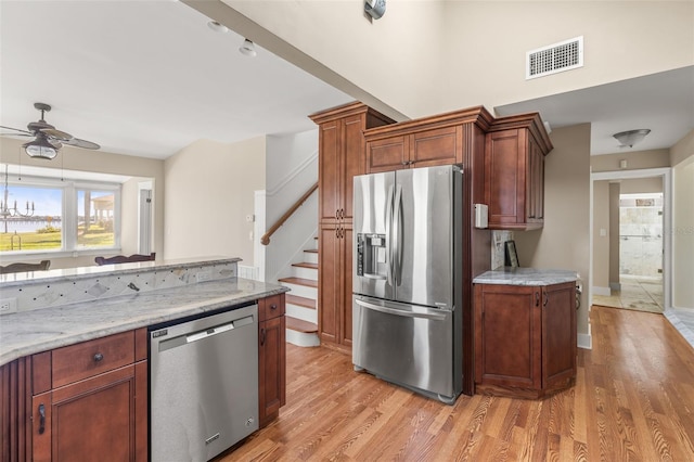 308 Chauncey Ave, Bradenton, FL 34208 - kitchen with a ceiling fan, stainless steel appliances, visible vents, light wood-style floors, and light stone counters