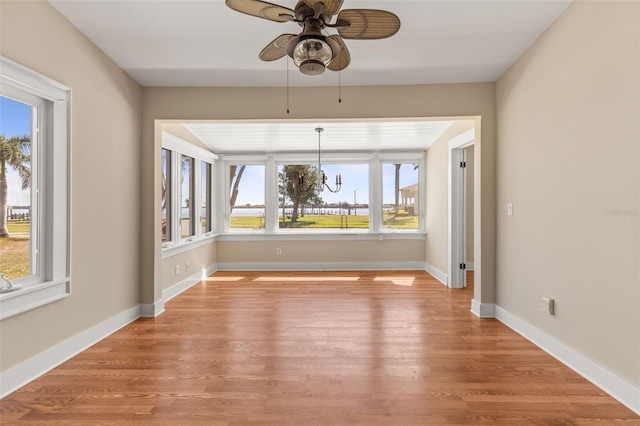 308 Chauncey Ave, Bradenton, FL 34208 - interior space with baseboards, light wood-style flooring, and ceiling fan with notable chandelier