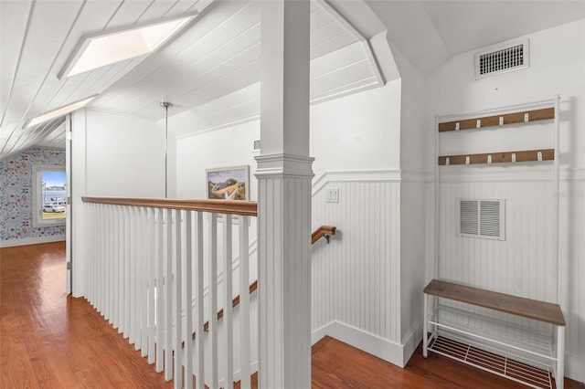 308 Chauncey Ave, Bradenton, FL 34208 - interior space with lofted ceiling with skylight, visible vents, a wainscoted wall, and wood finished floors