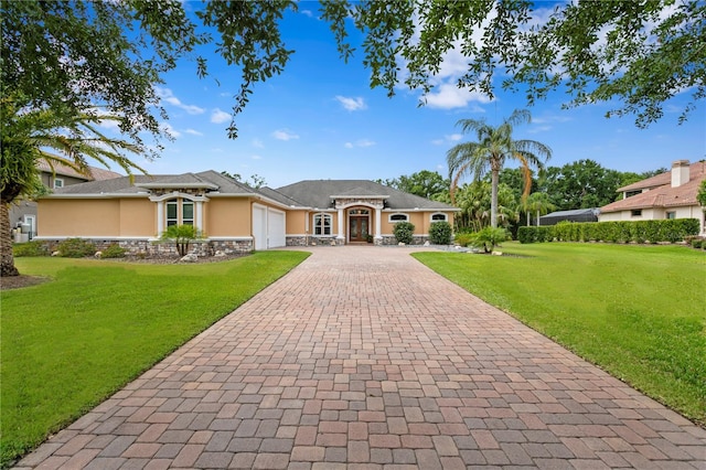 19815 Sea Rider Way, Lutz, FL 33559 - view of front of property featuring stucco siding, decorative driveway, an attached garage, stone siding, and a front lawn