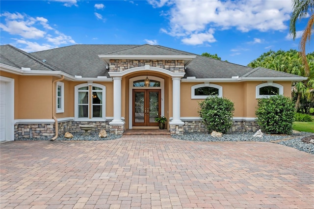 19815 Sea Rider Way, Lutz, FL 33559 - entrance to property with french doors, stucco siding, stone siding, and decorative driveway