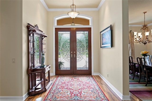 19815 Sea Rider Way, Lutz, FL 33559 - foyer with french doors, a chandelier, wood finished floors, plenty of natural light, and ornamental molding