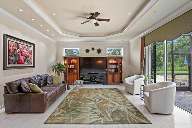 19815 Sea Rider Way, Lutz, FL 33559 - living room featuring a ceiling fan, crown molding, a tray ceiling, and wood finished floors