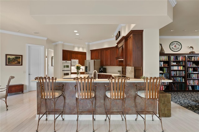 19815 Sea Rider Way, Lutz, FL 33559 - kitchen with white appliances, a peninsula, light countertops, light wood-style flooring, and recessed lighting