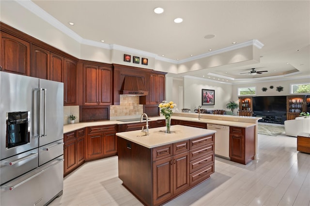 19815 Sea Rider Way, Lutz, FL 33559 - kitchen with high quality fridge, white dishwasher, custom exhaust hood, a center island with sink, and a peninsula