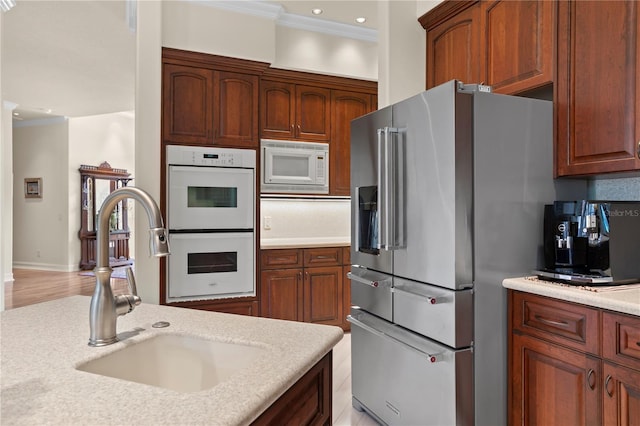 19815 Sea Rider Way, Lutz, FL 33559 - kitchen featuring white appliances, crown molding, light countertops, a sink, and recessed lighting