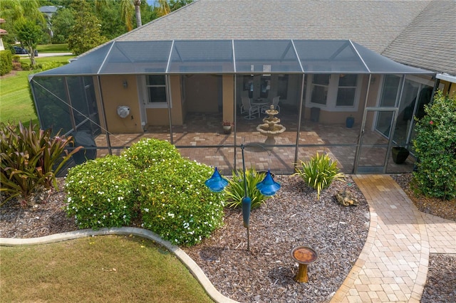 19815 Sea Rider Way, Lutz, FL 33559 - back of property featuring glass enclosure and a patio area
