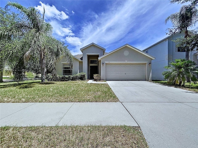 7504 Turtle View Dr, Ruskin, FL 33573 - view of front facade featuring a garage, concrete driveway, a front yard, and stucco siding