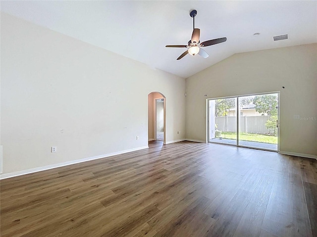 7504 Turtle View Dr, Ruskin, FL 33573 - empty room with arched walkways, a ceiling fan, wood finished floors, and vaulted ceiling