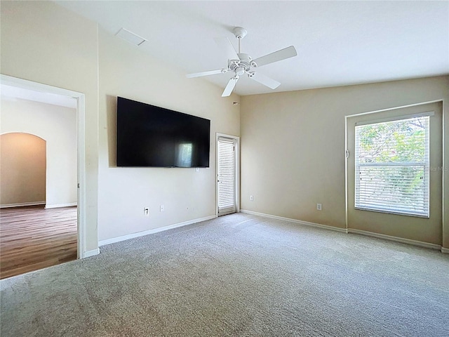 7504 Turtle View Dr, Ruskin, FL 33573 - unfurnished living room featuring arched walkways, carpet flooring, and ceiling fan