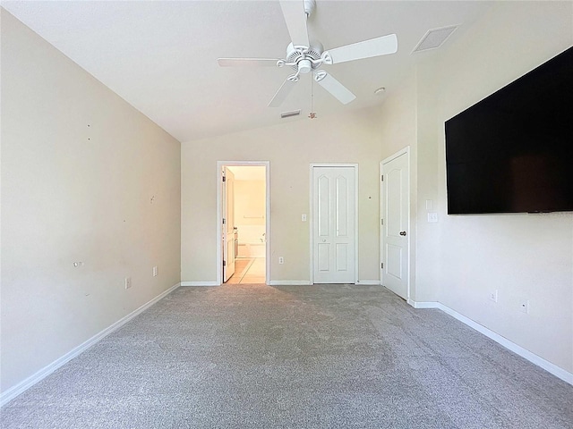 7504 Turtle View Dr, Ruskin, FL 33573 - unfurnished bedroom featuring light colored carpet, vaulted ceiling, ensuite bathroom, and a ceiling fan